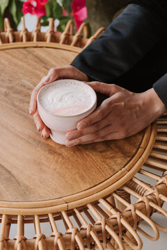 Woman holding rose latte