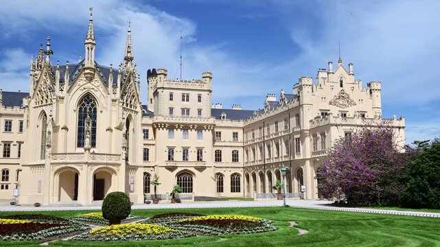 Lednice Castle above a manicured lawn with a round ornamental flowerbed, Czech Republic