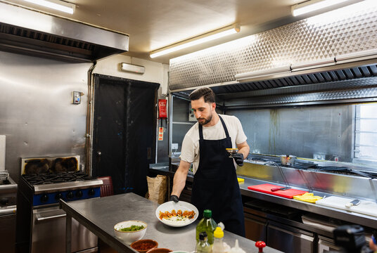 Chef finishing traditional Turkish kebab at a professional kitchen