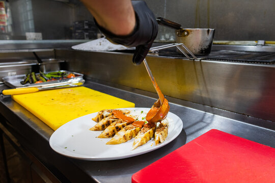 Chef finishing a Beyti kebab plate