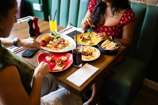 High-angle shot of two friends sharing a traditional Turkish meal