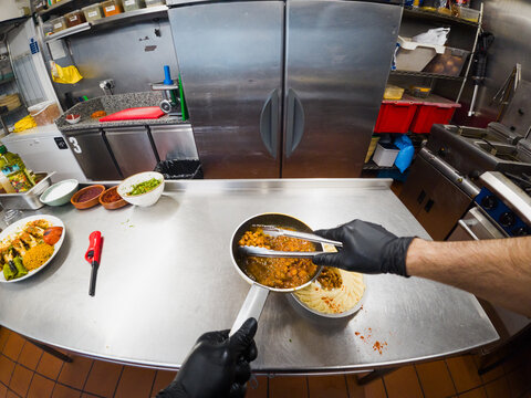 POV of chef plating curry