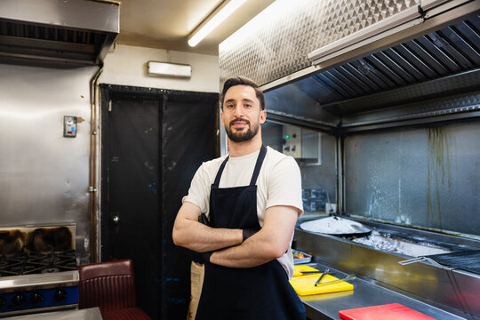Confident chef standing in restaurant kitchen