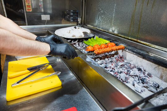Placing the skewers over hot coals