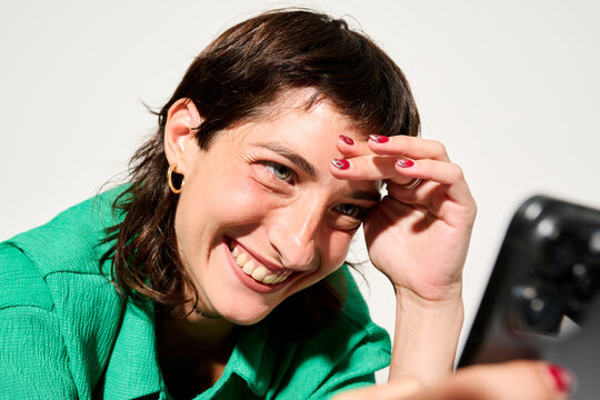 Smiling Brunette looking at mobile phone