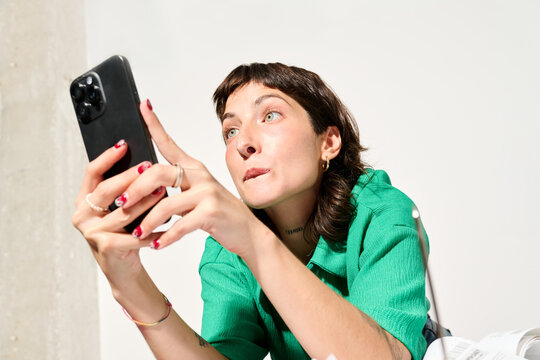 Staring in astonishment at her phone