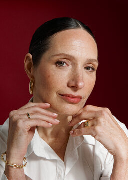 Woman with delicate makeup and red lips posing