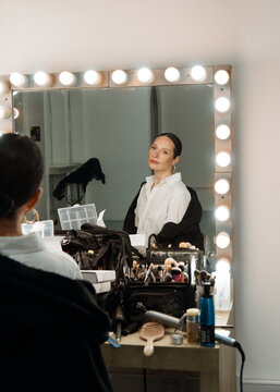 Makeup Session at a Vanity Mirror in a Bright Studio