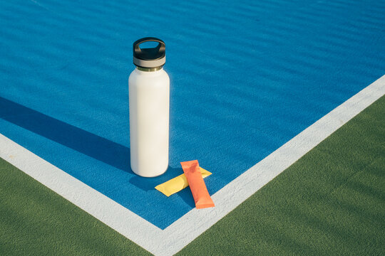 Reusable water bottle electrolyte packets sports court