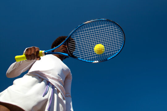 Black man tennis player with racket and ball.