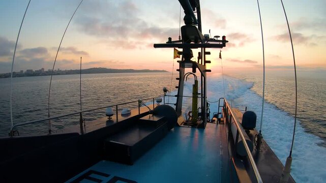 Aerial view of a fast coast guard of the Spanish Customs sailing at sunrise in the Mediterranean Sea.