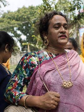 Conceptual documentary-style portrait representing India&rsquo;s hijra community, with a person wearing traditional sari and jewelry at an outdoor gathering.