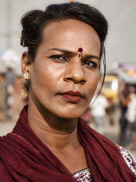 Conceptual documentary-style portrait representing India&rsquo;s hijra community, with a person wearing traditional clothing and bindi at an outdoor gathering.