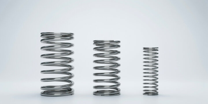 Three helical steel compression springs of different sizes on a white background