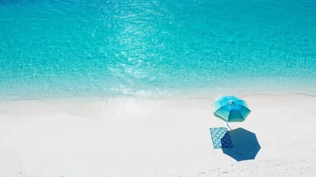 Aerial view of beach umbrellas on pristine white sand by turquoise ocean