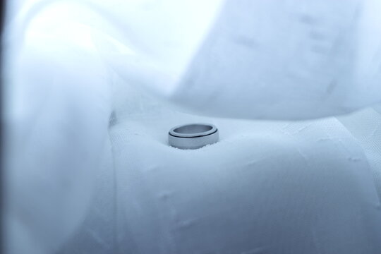 Wedding Ring on White Fabric