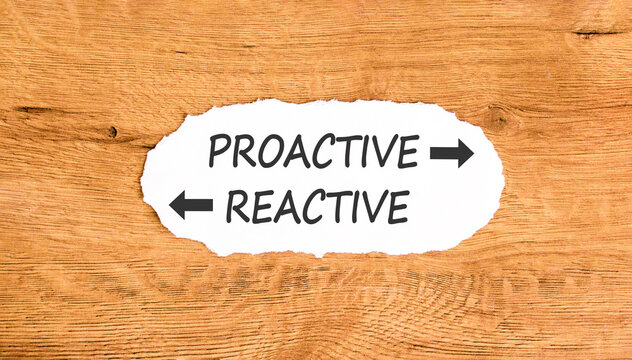 Proactive and reactive symbol. Concept word Proactive Reactive on beautiful white paper. Beautiful wooden background. Business proactive and reactive concept. Copy space.