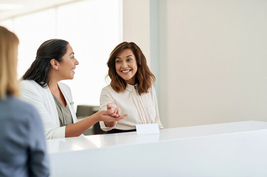 Dental Office Staff Assisting Patient at Reception Desk
