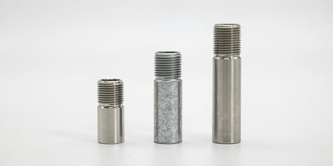Fototapeta premium Three metal threaded pipe nipples of different sizes on a white background