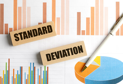 Standard deviation concept with wooden blocks, financial charts and pen, representing statistics, data analysis, risk measurement