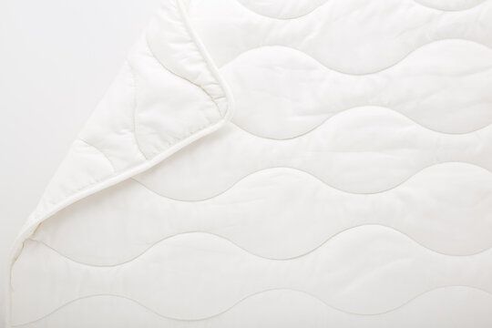 New clean white fibre duvet. Closeup. Flat lay. Top down view.