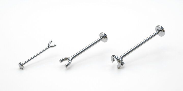 Three silver metal piercing jewelry pieces on a white background