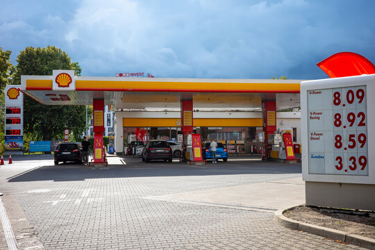 Warsaw, Masovian, Poland - July 24 2026: A modern Shell gas station daytime view featuring canopy pumps, price signs, and cars.