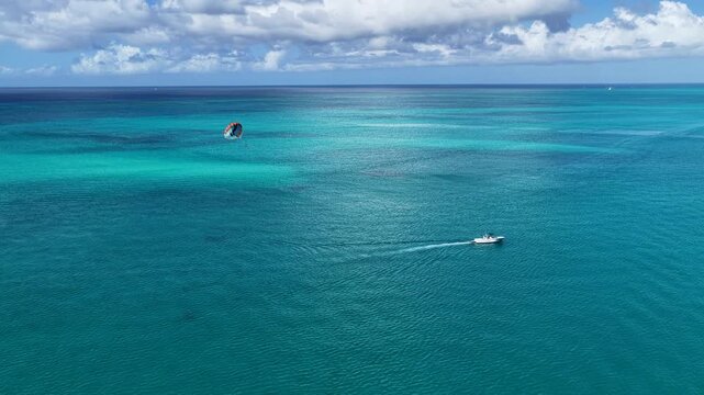 Parasail In Providenciales Overseas Territory Turks And Caicos Islands. Bird Eye View Of Stunning Parasailing Scene Over A Blue Ocean. Tropical Skyline. Bay Water Landscape.