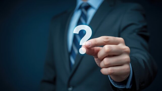 Businessman holding a glowing question mark
