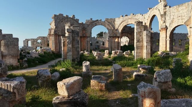 Aerial drone view of the historic ruins of Qal'at Semaan in Syria. Ancient stone architecture and arches at the Church of Saint Simeon Stylites. Famous archaeological site.