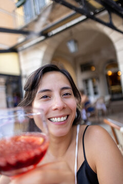 She&rsquo;s laughing while having a glass of wine