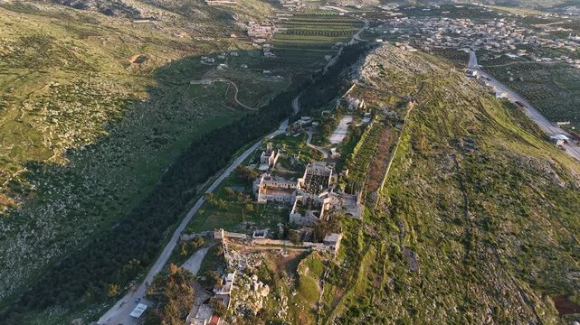 Aerial drone view of the historic ruins of Qal'at Semaan in Syria. Ancient stone architecture and arches at the Church of Saint Simeon Stylites. Famous archaeological site.
