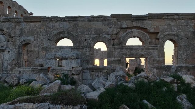 Scenic aerial drone shot of Qal'at Semaan historic site at sunset. Sunset background with an archaeological site. Ancient ruins and heritage in Syria. Tourism in post-war Syria.