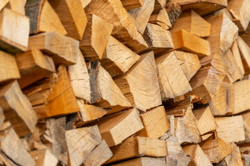 Fototapeta premium Stacked firewood logs texture background, chopped wood pile close-up, natural fuel material