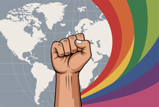 Raised human fist of solidarity in front of a world map and colorful rainbow stripes, representing global pride and rights.