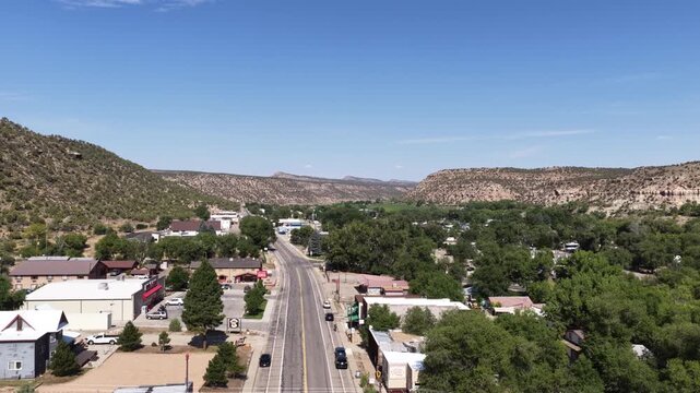 Aerial of Naturita Colorado townscape in high desert mountain valley with main street and desert bluffs