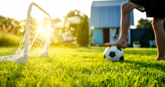 Golden sun glows behind a soccer goal