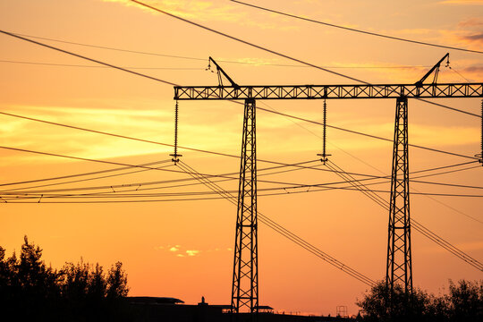 Golden sky frames towering power lines