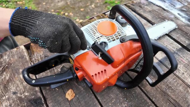 Portable chainsaw placed on timber during forestry work, professional equipment, wood processing, arborist tools, outdoor industry.