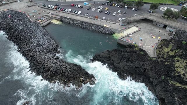 Aerial panoramic view of Pocos de Sao Vicente Ferreira, a volcanic natural swimming area on the north coast of Sao Miguel Island, Azores, Portugal.