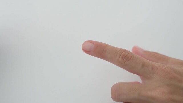 Gloved hands place a pulse oximeter on a finger for oxygen measurement