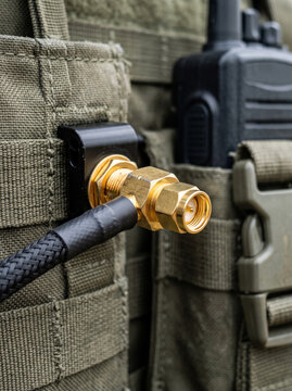 High frequency coaxial cable connector attached to tactical vest radio pocket