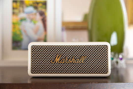 Marshall Emberton III cream wireless bluetooth speaker on shelf in home interior cozy background