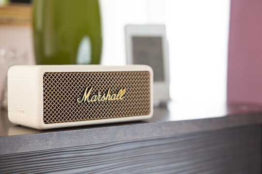 Marshall Emberton III cream wireless bluetooth speaker on shelf in home interior cozy background