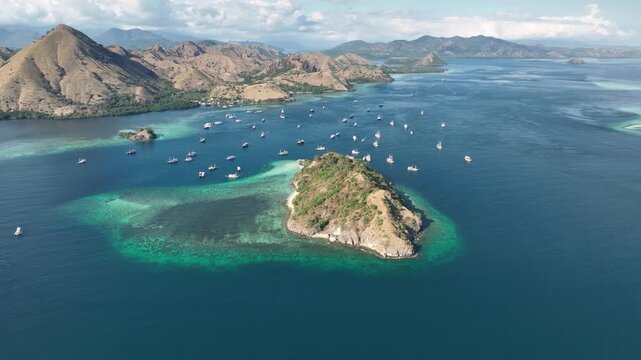 Aerial view of Pulau Kelor surrounded by turquoise waters and coral reefs in Komodo, East Nusa Tenggara, Indonesia.
