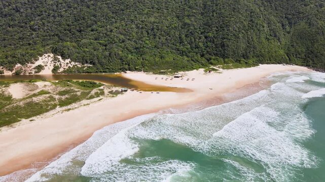 Drone View of Lagoinha do Leste Beach and Rustic Coastal Shelter in Florianopolis Brazil, Mountain River Meeting Turquoise Ocean Waves, Wild Atlantic Forest Landscape Summer Travel Footage
