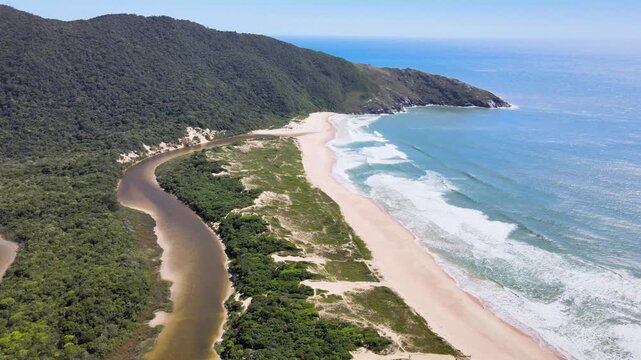 Drone View of Lagoinha do Leste Beach and Curved Freshwater River in Florianopolis Brazil, Wild Coastline with White Sand Dunes and Green Mountains, Isolated Atlantic Forest Summer Travel Footage
