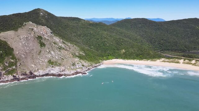 Drone Aerial Panning Shot of Lagoinha do Leste Beach in Florianopolis Brazil, Pristine Deserted Coastline, Turquoise Ocean Waves and Green Mountains, Wild Atlantic Forest Landscape Travel Footage