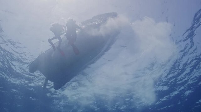 Small boat tending to divers on surface.