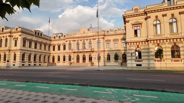 Pan of the Bacău Prefecture, also known as the Administrative Palace &mdash; a grand neoclassical government building in Romania under a dramatic evening sky.